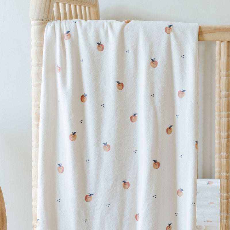 Saranoni Minky Stretch Luxe Swaddle/Blanket in Apple supports secure wrapping and works beautifully as a baby swaddle.