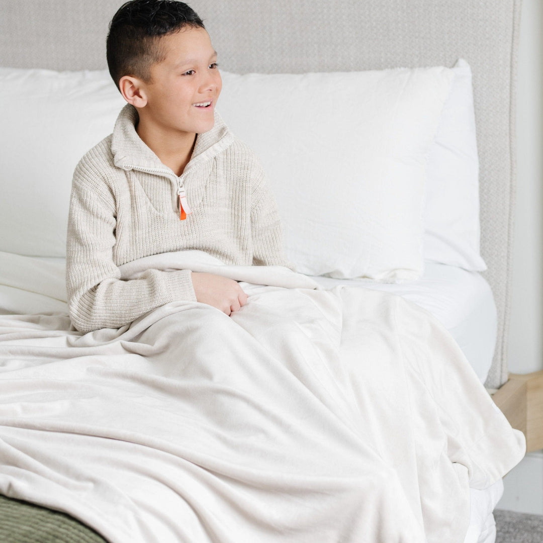 Wrap your infant in comfort with the Saranoni Minky Stretch Receiving Blanket in Buttermilk, a favorite among receiving blankets.