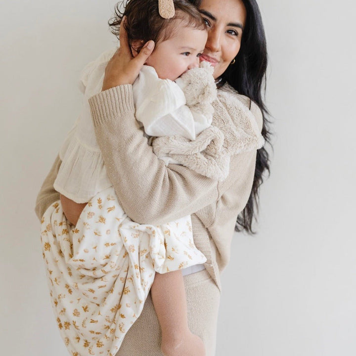 Wrap your little one in the Saranoni Minky Stretch Receiving Blanket in Florals, one of the best baby blankets for year-round use.