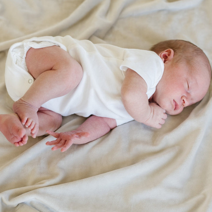 SaranoniÕs Minky Stretch Receiving Blanket in Buttermilk surrounds your baby with softness Ñ an essential receiving blanket.
