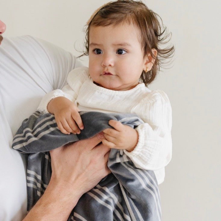 A beautiful blend of comfort and charm, the Saranoni Minky Stretch Receiving Blanket in Stripe is the ideal baby girl blanket.