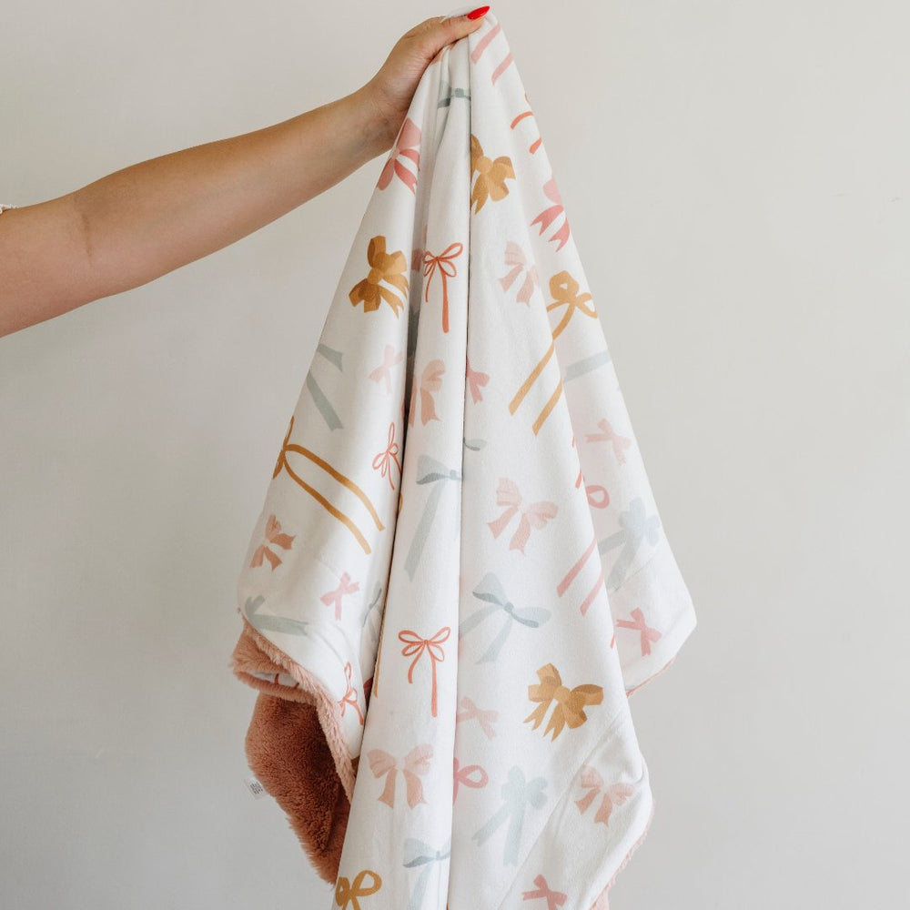 Wrap your newborn in Bows Saranoni Minky/Lush Receiving Blanket, one of the best baby blankets for naps.