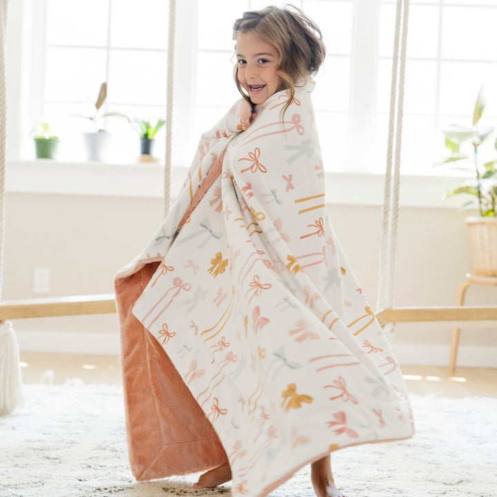 Experience the plush Saranoni Minky/Lush Toddler Blankets in Bows, an ideal baby blanket choice that adds warmth and luxury