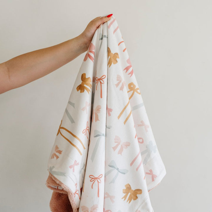 Snuggle your little one in the Minky/Lush XL Blanket in Bows by Saranoni, soft baby blanket.