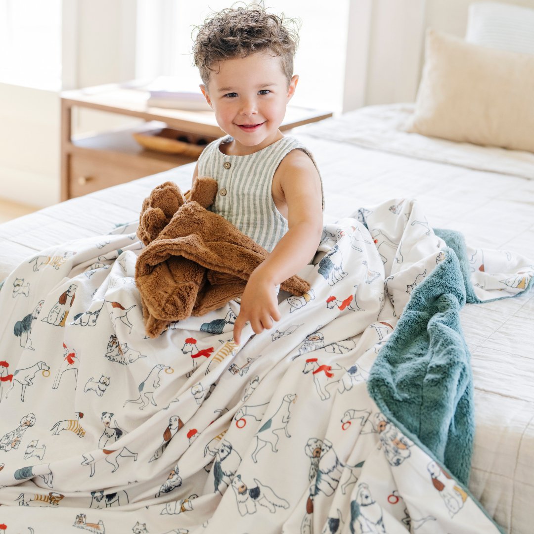 Saranoni Minky/Lush XL Blanket in Dogs is a baby knit blanket that offers snuggly softness.