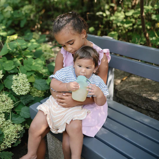 Lifestyle scene with Uppababy mushie silicone puree pouch 2-pack in Tradewinds, infant safe for everyday use.