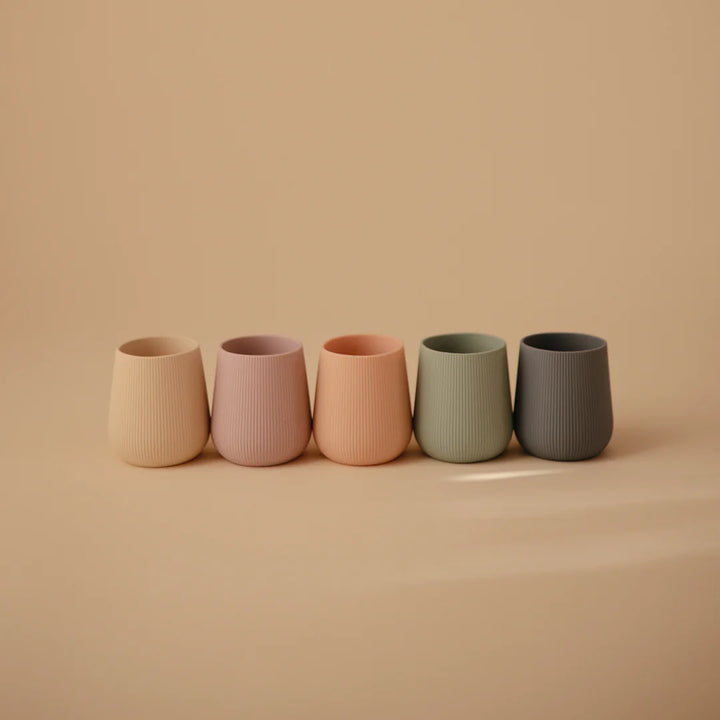 Close-up of Uppababy mushie silicone starter cup in Blush, crafted from non toxic material.