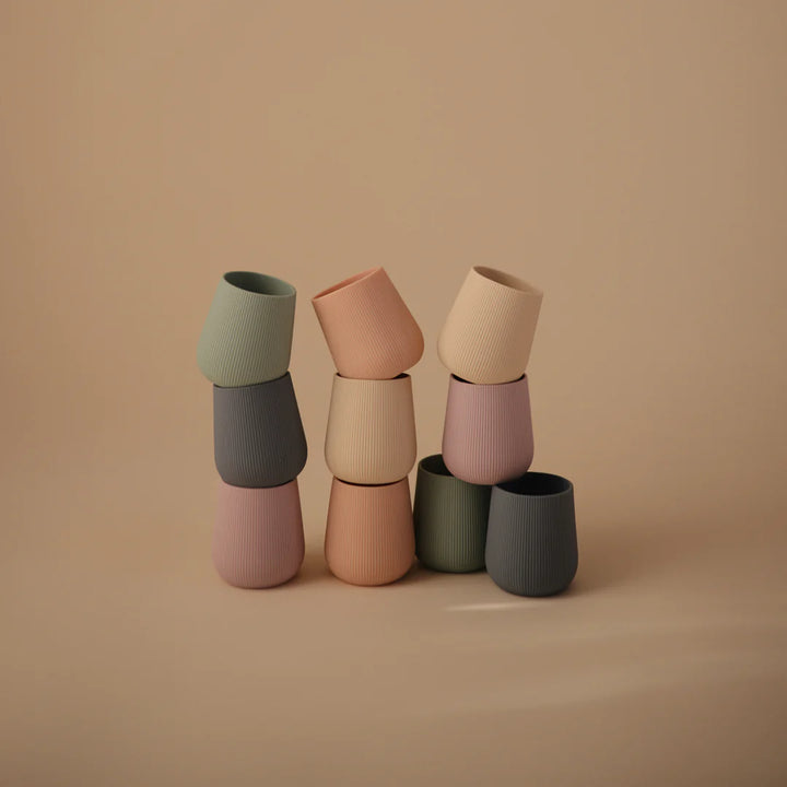 Blush Uppababy mushie silicone starter cup, dishwasher safe for quick and simple cleaning.