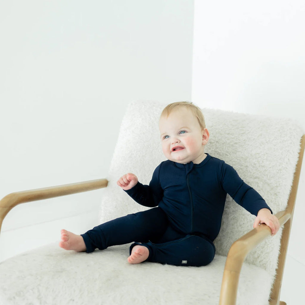 Baby in the cozy Kyte Zipper Romper in the shade Navy.