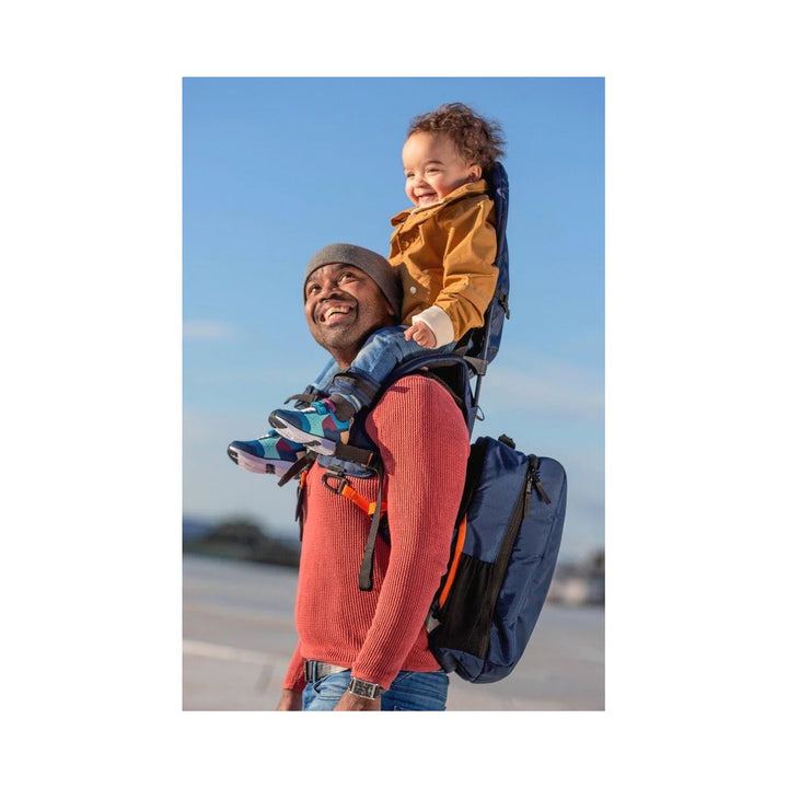 Happy baby using the navy/black shoulder carrier
