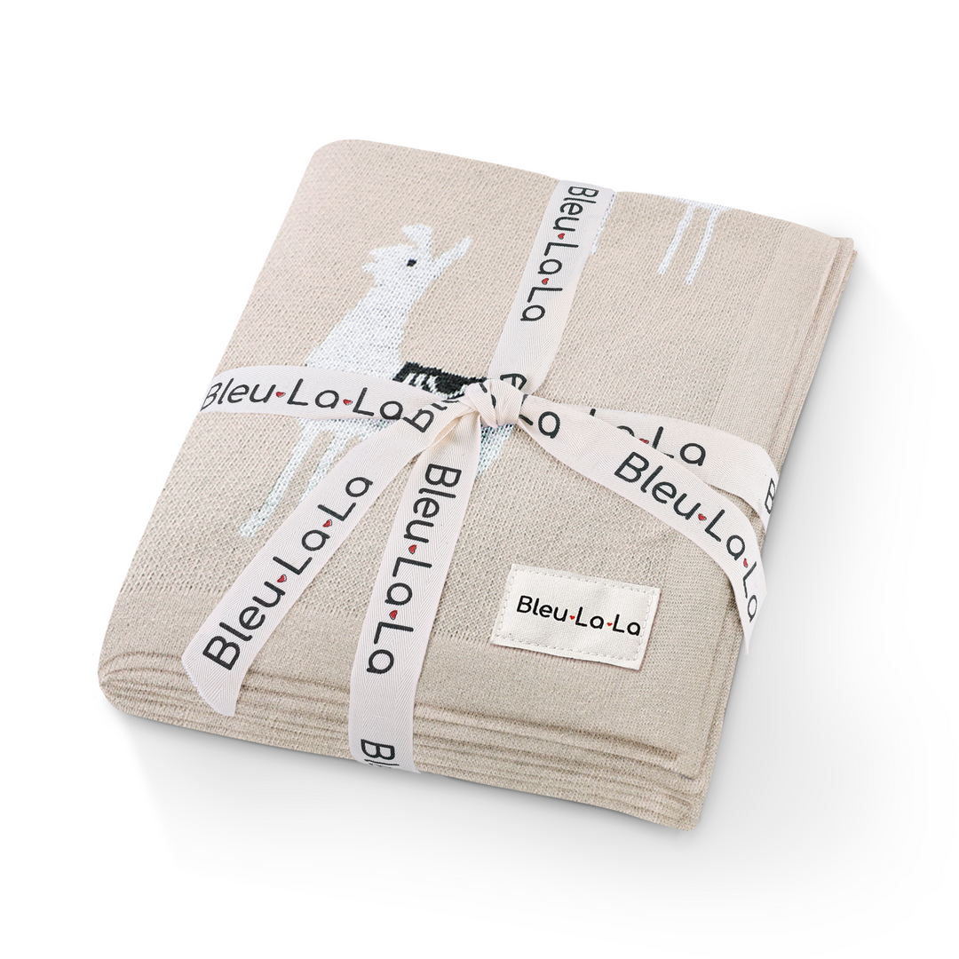 Bleu La La Knit Llama Swaddle in camel wrapped in a Bleu La La ribbon