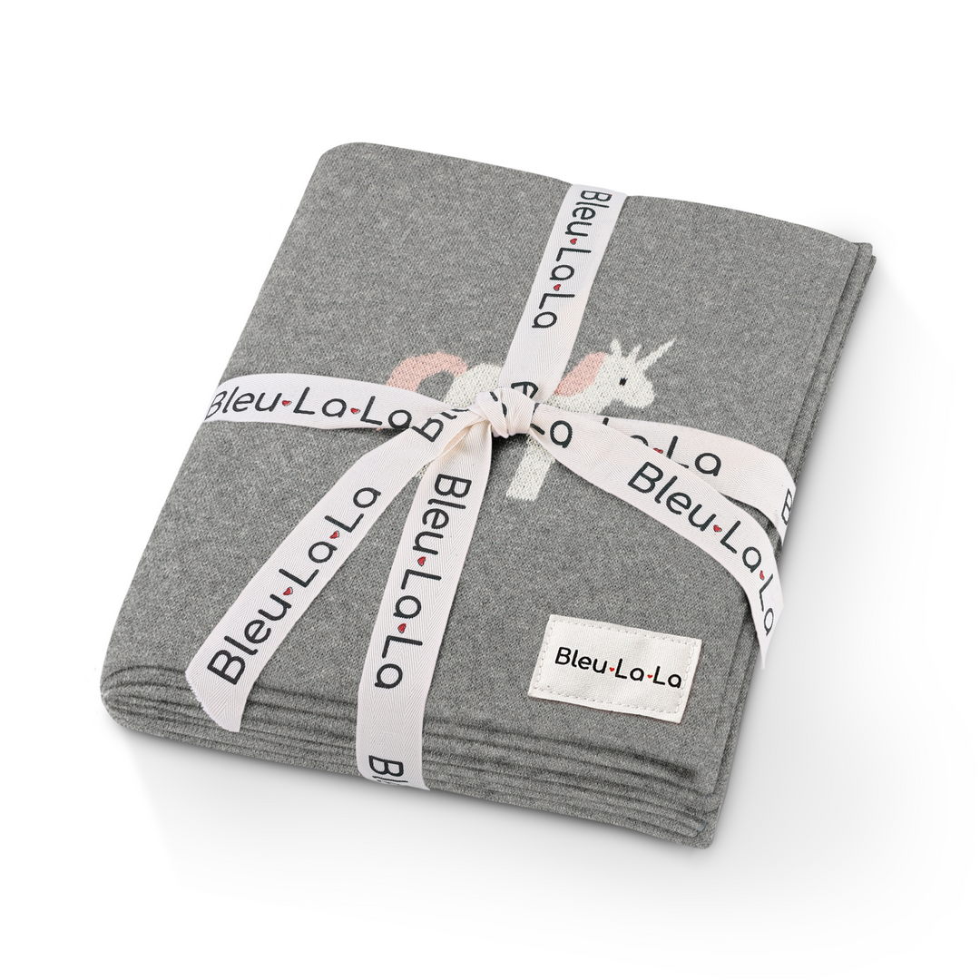 Gift-ready Bleu La La unicorn knit baby blanket wrapped with ribbon, neutral baby shower gift idea