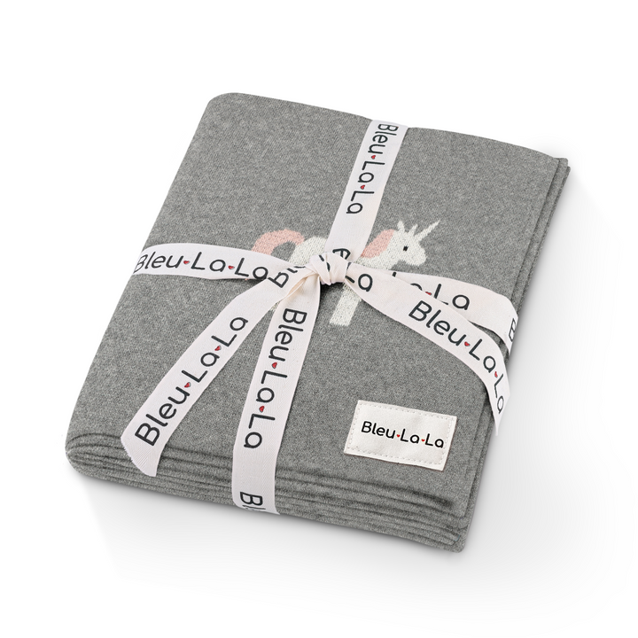 Gift-ready Bleu La La unicorn knit baby blanket wrapped with ribbon, neutral baby shower gift idea
