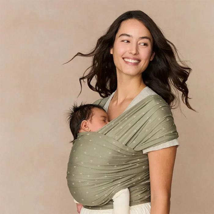 Stylishly secure, the Ergobaby Aura Baby Wrap in Olive Diamonds is a lightweight baby wrap sling for outings.