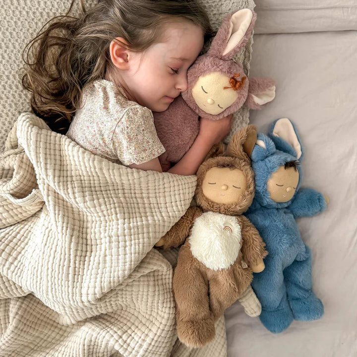 child sleeping and holding olli ella cozy dinkums bunny pickle 