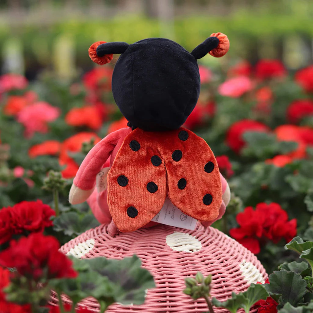 olli ella lola lady bug soft posable doll toy in field of carnations which match her red wings and red tipped feelers 