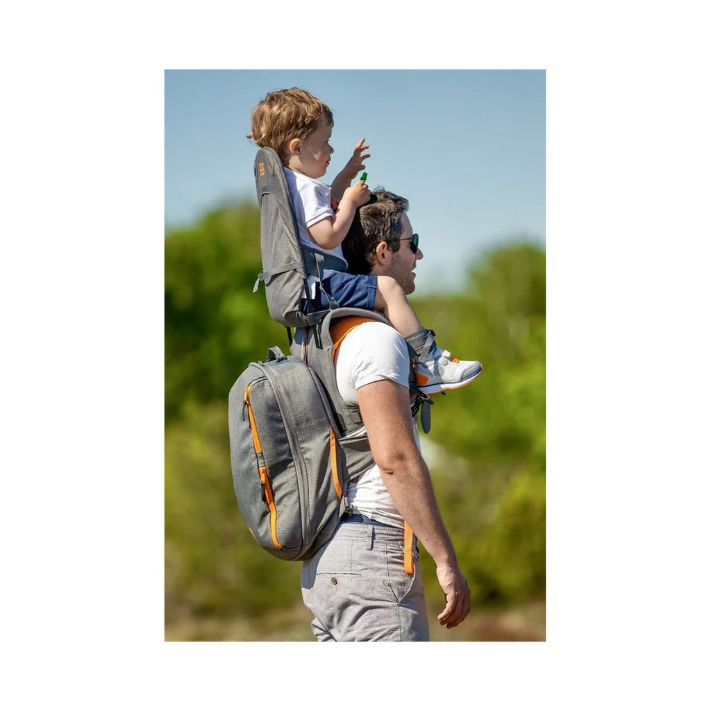 Side view of child and dad using the backpack and shoulder carrier