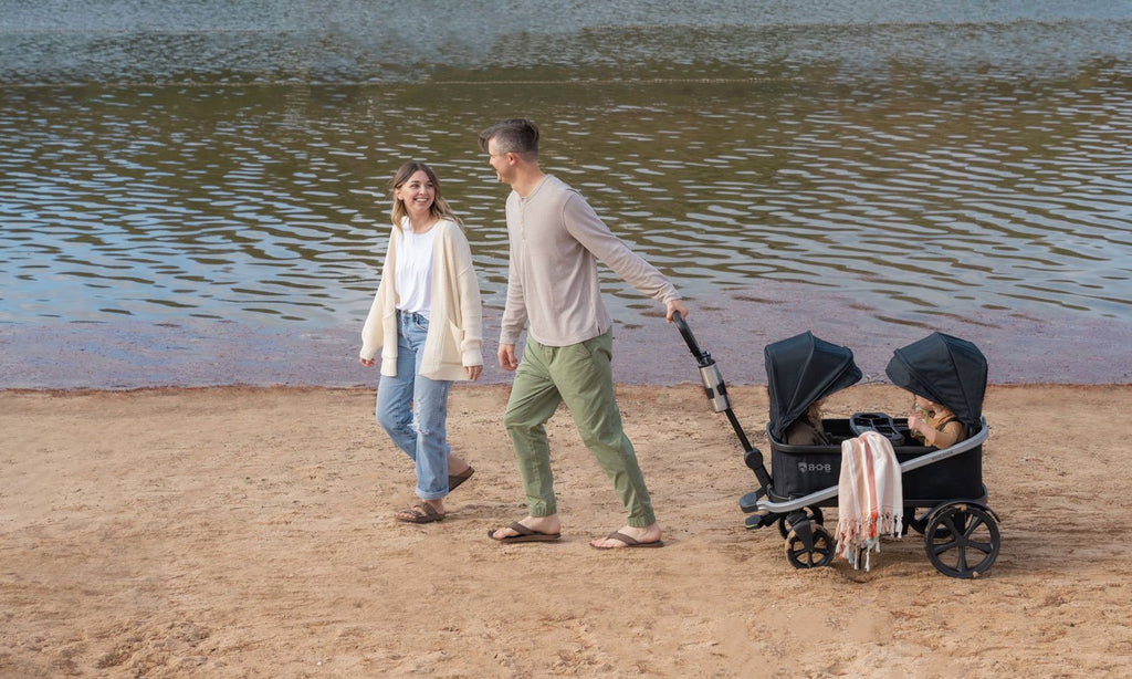 family on beed with bob renegade folding wagon with canopy