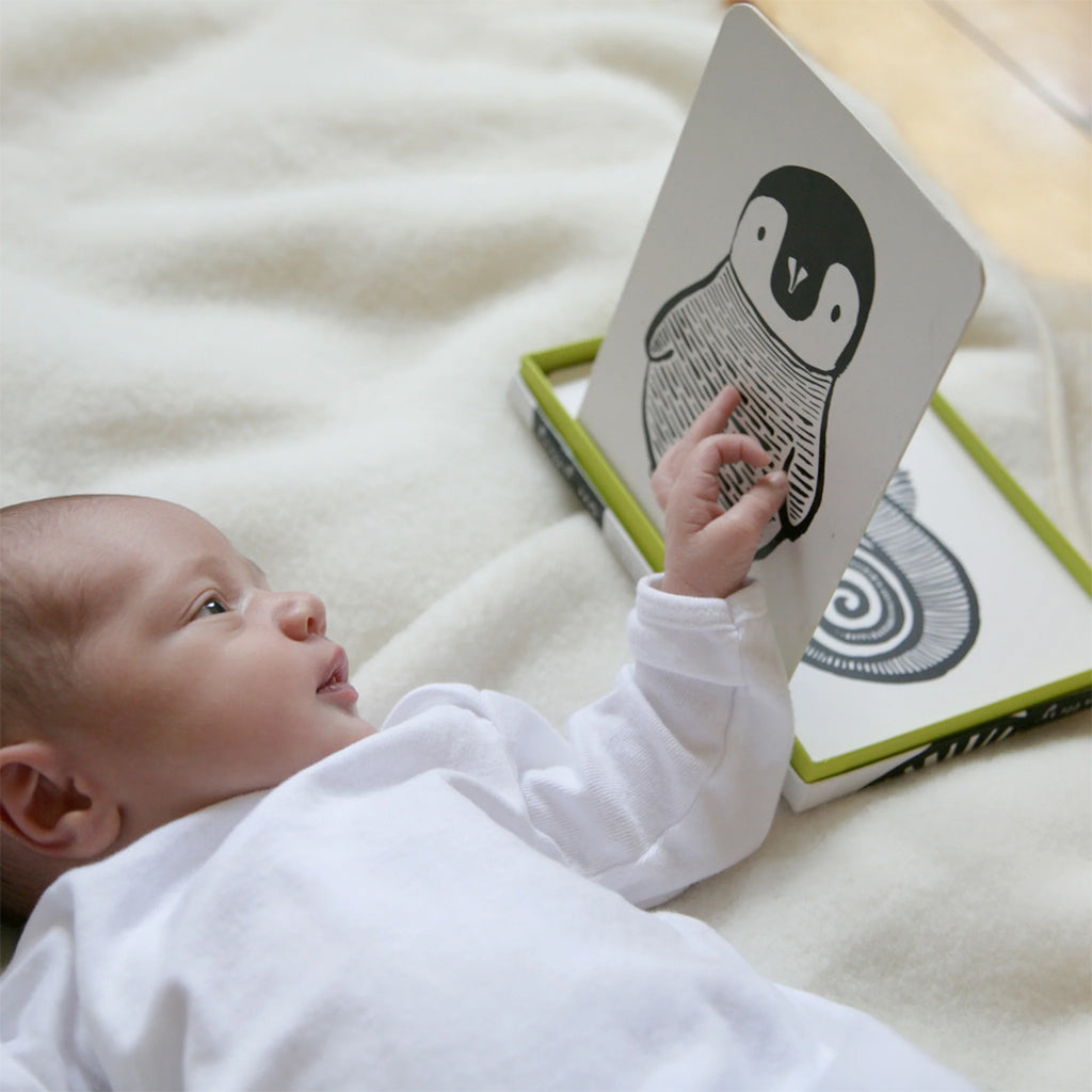 Baby playing with Penguin card by wee gallery