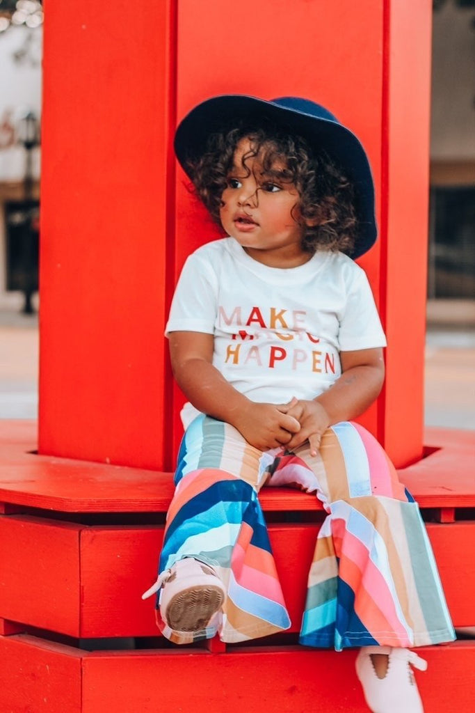 Little girl wearing a pair of Little Love Bug Company pink t-bar shoes.