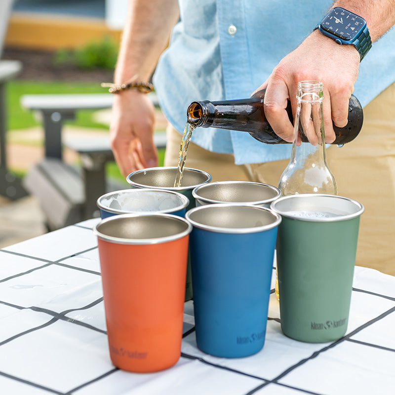 Pouring beer from Klean Kanteen 16oz Pint Cup Four Pack in Black, stainless steel and non toxic design.