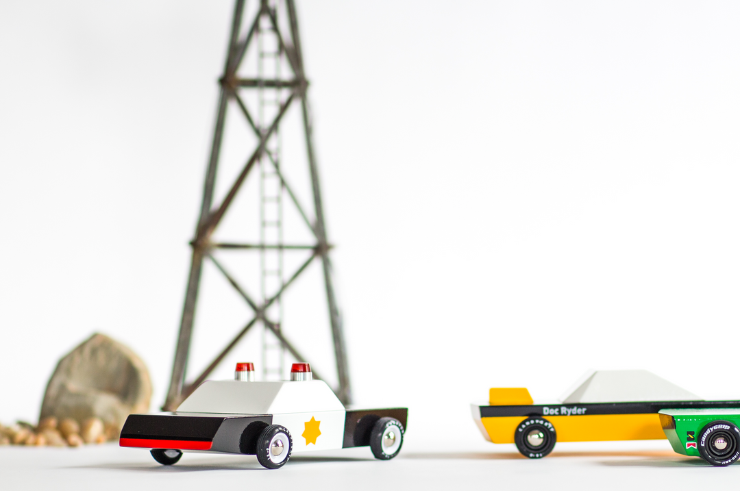 The Plantoys Police Cruiser photographed in a clean studio shot, ideal for shoppers looking for toy police car options.