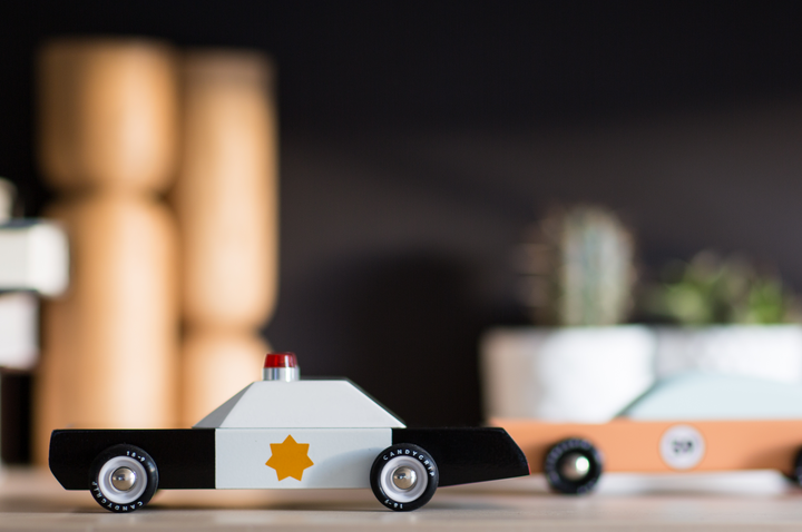 Front-facing view of the Plantoys Police Cruiser, presented as a durable car toy for active little drivers.