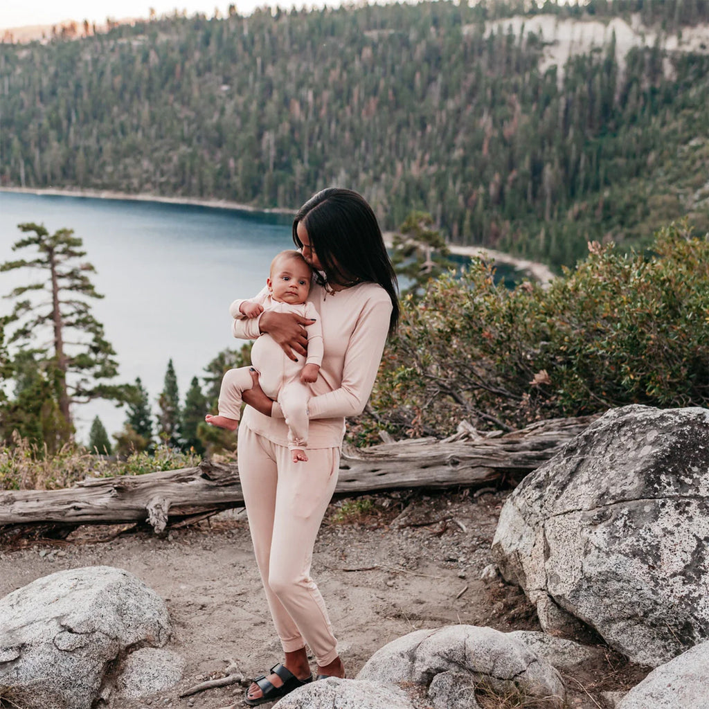 Mom and baby in nature wearing the zipper romper in the color porcelain.