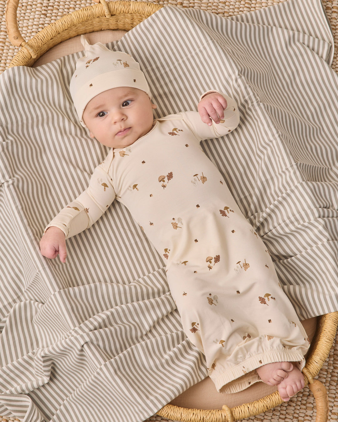 Woodland bamboo baby gown and knotted hat by Quincy Mae, studio photo