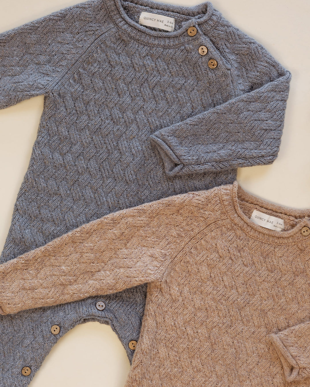 Styled flat lay of Quincy Mae gray knit jumpsuit for baby, Cozy Heather Heathered Slate