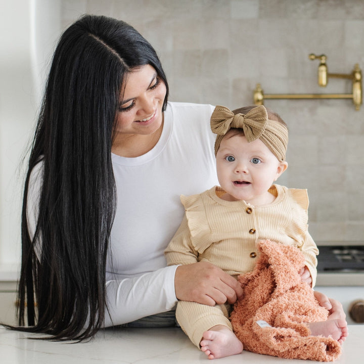 With a soothing ribbed design, the Saranoni Ribbed BAMBONI¨ Mini Blanket in Sun-Kissed stands out among the best baby blankets.