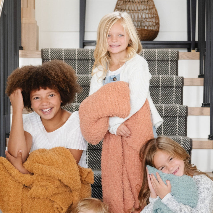Wrap your toddler in warmth with the Saranoni Ribbed BAMBONI¨ Blanket, shown here in Golden, Sun-Kissed, and Surf colors.