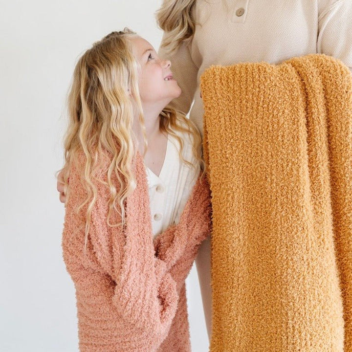 The Saranoni Ribbed BAMBONI¨ Toddler Blanket in Sun-Kissed and Golden offers softness and comfort.