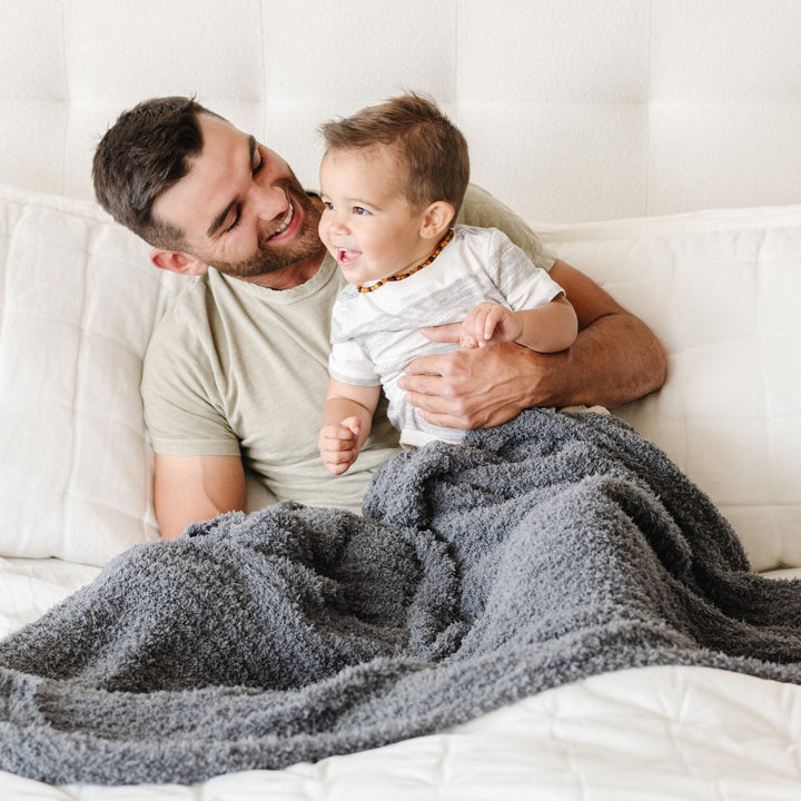 The Saranoni Ribbed BAMBONI¨ Toddler Blanket in Charcoal offers comfort and gentle warmth.