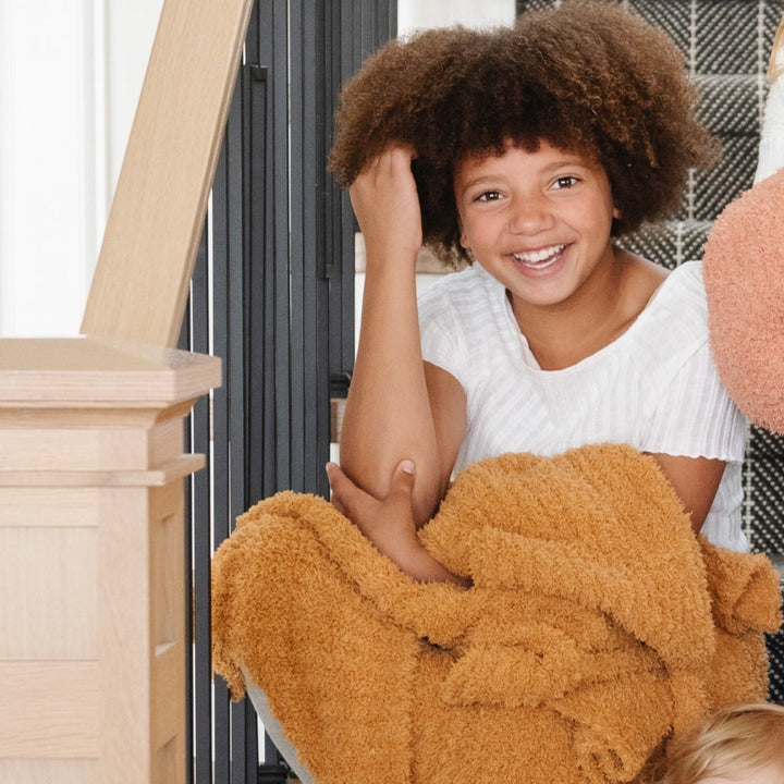 Golden Saranoni Ribbed BAMBONI¨ Toddler Blanket brings warmth and softness to any nursery.