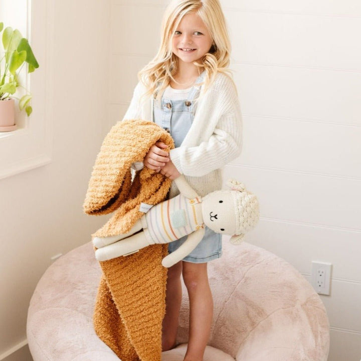 Soft baby girl blankets from Saranoni Ribbed BAMBONI¨ in Golden provide cozy warmth.