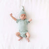 tiny baby wearing Kyte Baby sage knotted cap