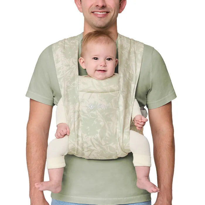 Shown in Sage, the Ergobaby Embrace Newborn Carrier brings cozy support as the best baby carrier for newborns.