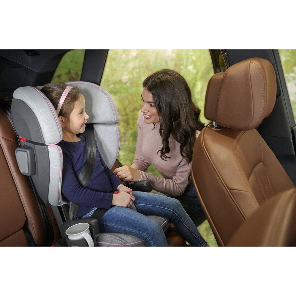 mom buckling child into sasha alta booster car seat