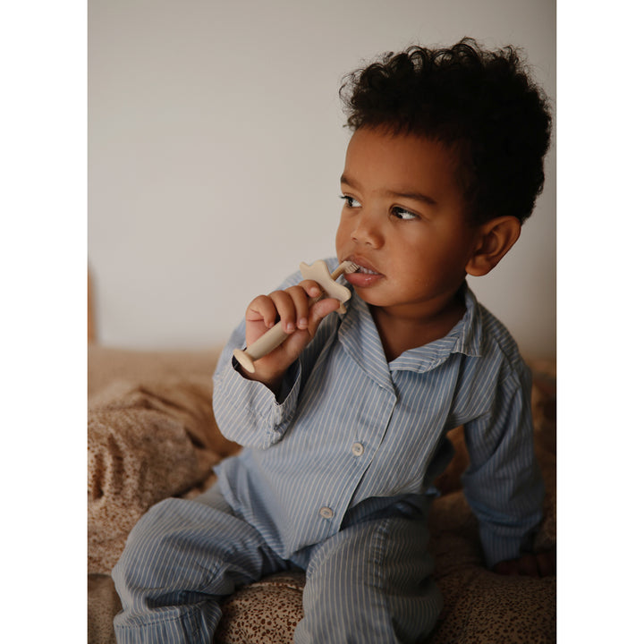 Child Using Training Toothbrush Child brushing with a gentle training toothbrush perfect for early oral care