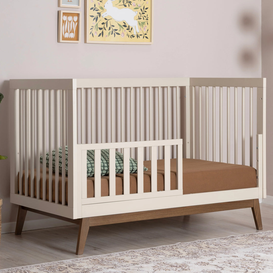 Beautiful Dadada Soho 3-in-1 Convertible Crib in almond milk walnut finish featured as a wooden crib.