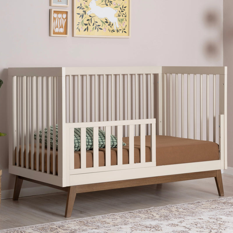 Beautiful Dadada Soho 3-in-1 Convertible Crib in almond milk walnut finish featured as a wooden crib.