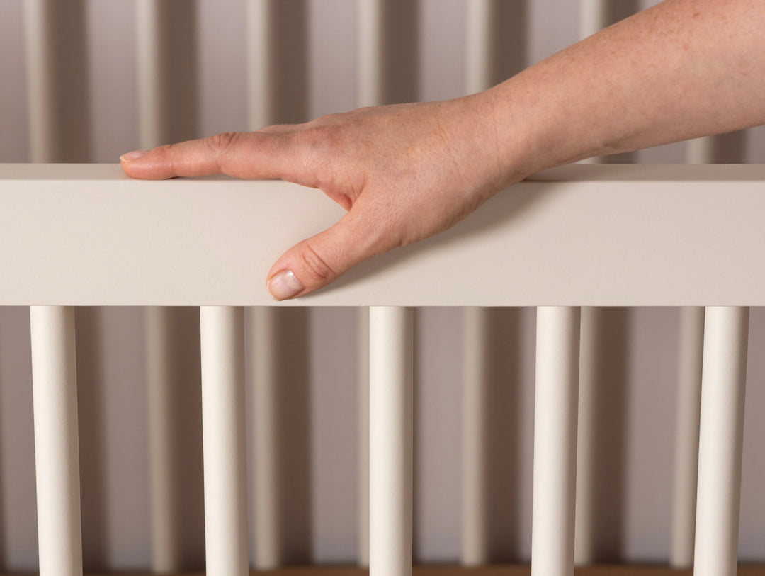 Front view of the Dadada Soho 3-in-1 Convertible Crib in almond milk walnut presented as a cribs for babies option.