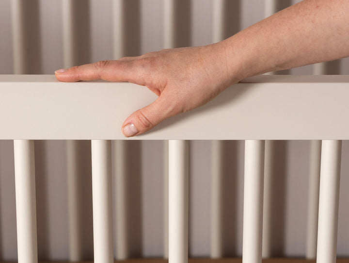 Front view of the Dadada Soho 3-in-1 Convertible Crib in almond milk walnut presented as a cribs for babies option.