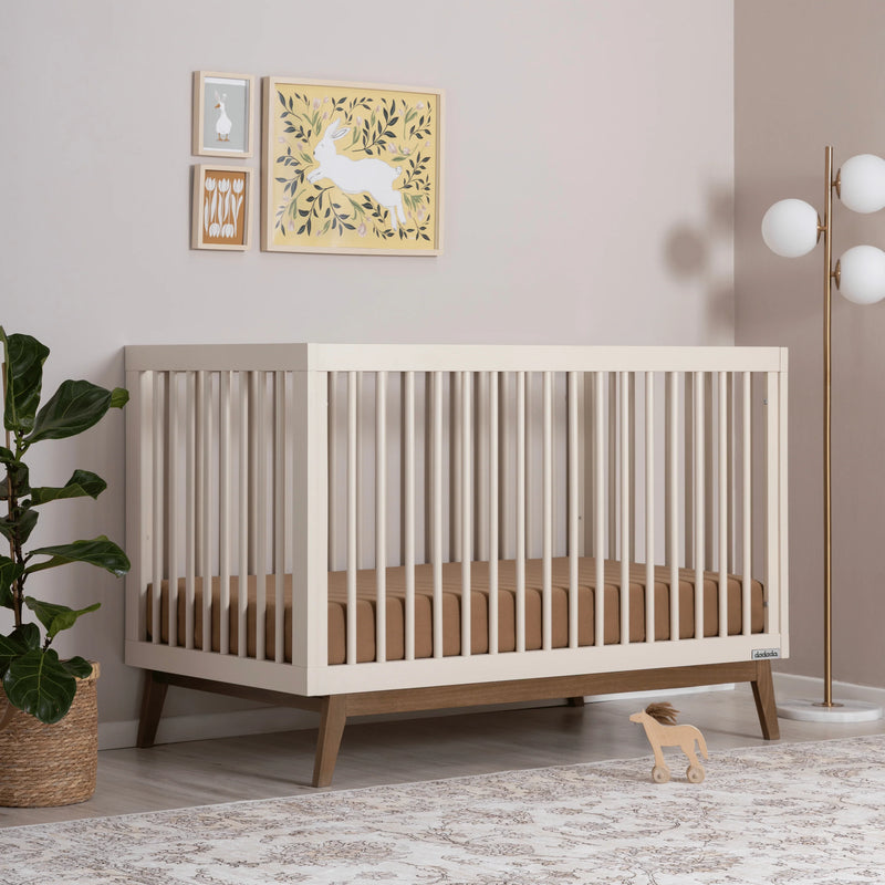 Stylish Dadada Soho 3-in-1 Convertible Crib in almond milk walnut featured as a best cribs option.