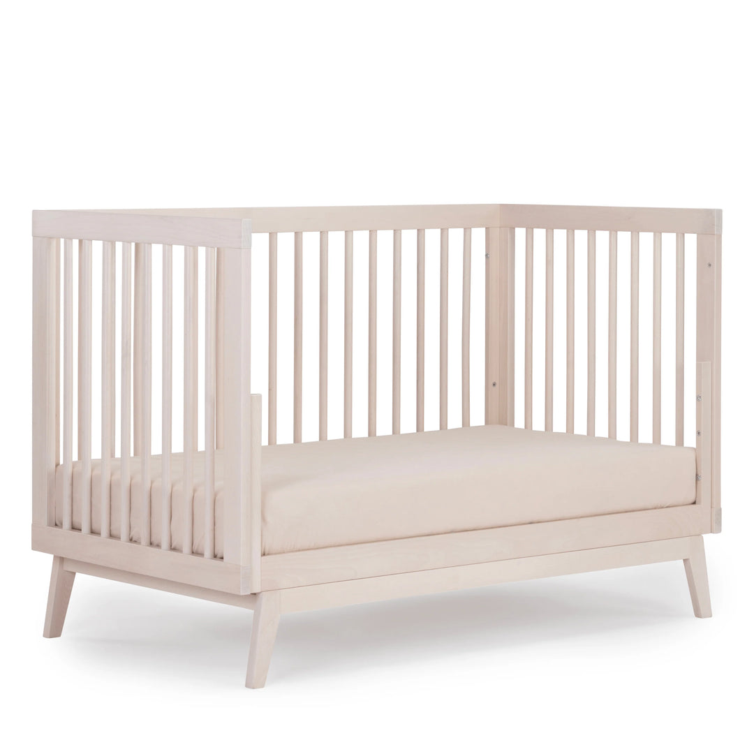 Warm wood accents give the Dadada Soho 3-in-1 Convertible Crib in Wash the appeal of a premium infant crib.