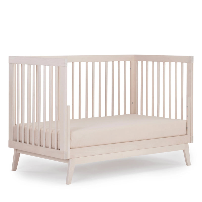 Warm wood accents give the Dadada Soho 3-in-1 Convertible Crib in Wash the appeal of a premium infant crib.