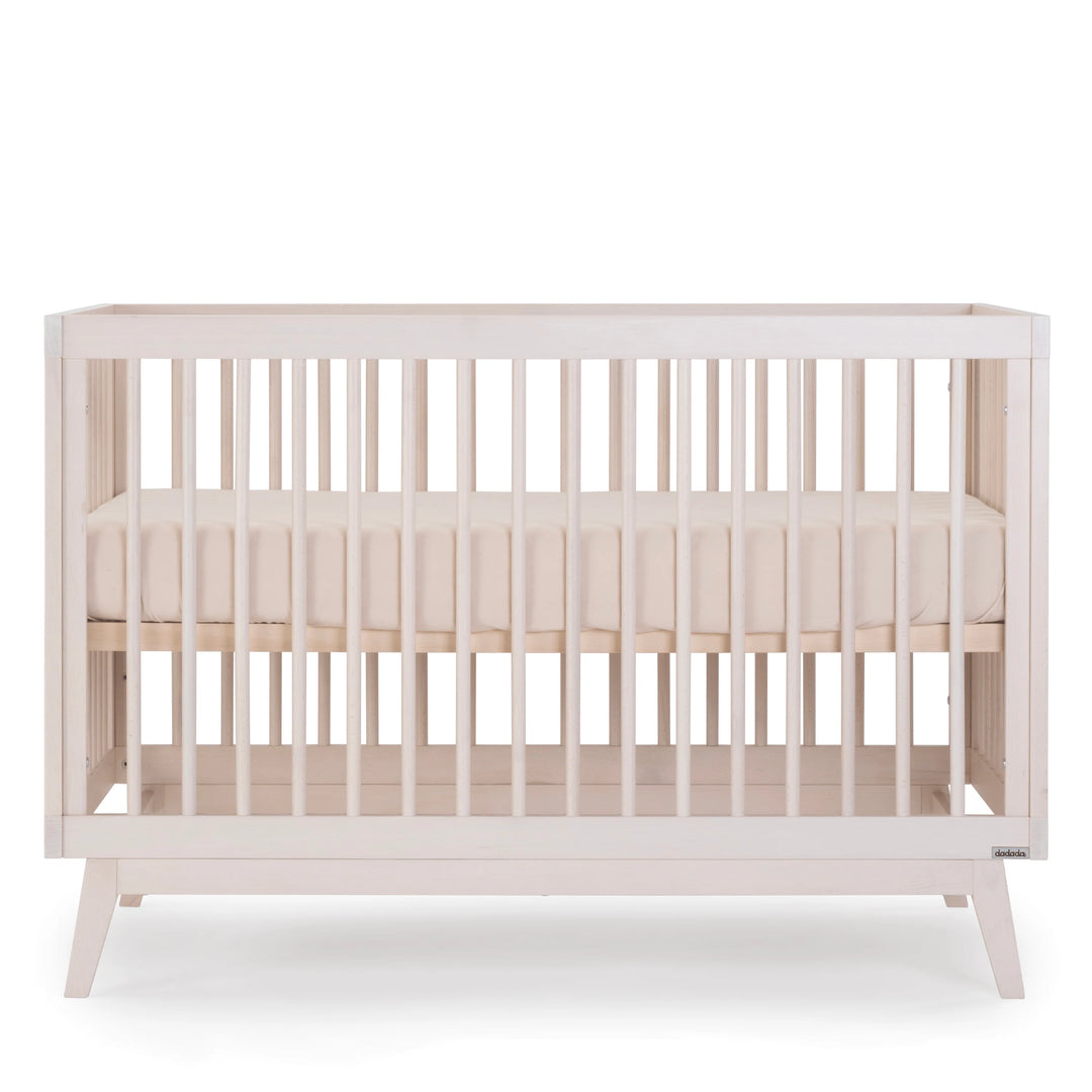 Sleek craftsmanship makes the Dadada Soho 3-in-1 Convertible Crib in Wash a stylish wood crib for any nursery space.