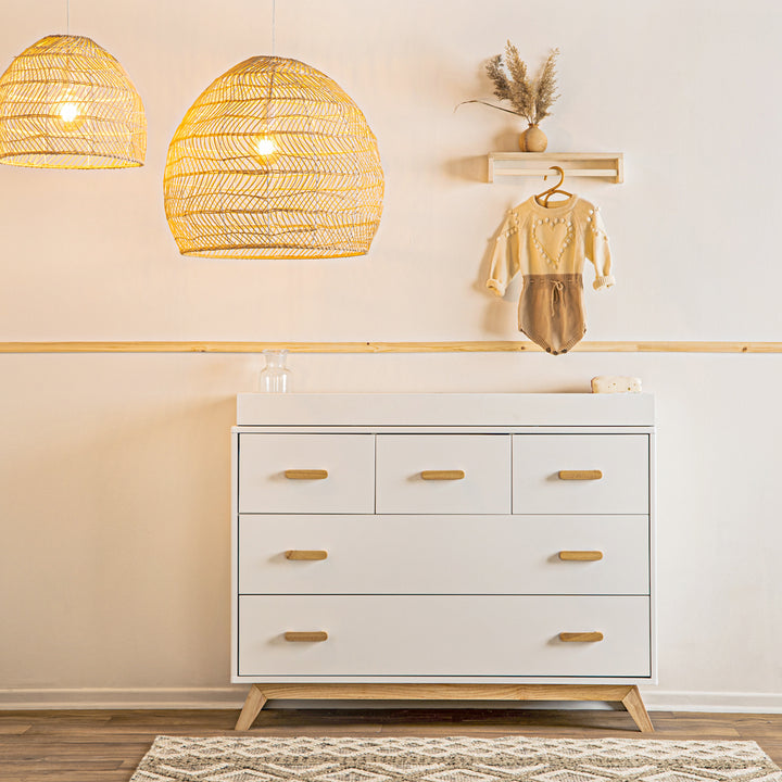 Natural accents give the Dadada Soho 2.0 5-Drawer Dresser in White/Natural the charm of real wood dressers.