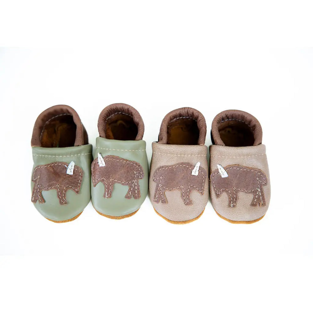 white background with two pair of handmade leather baby shoes with western buffalo patches created by starry night design 